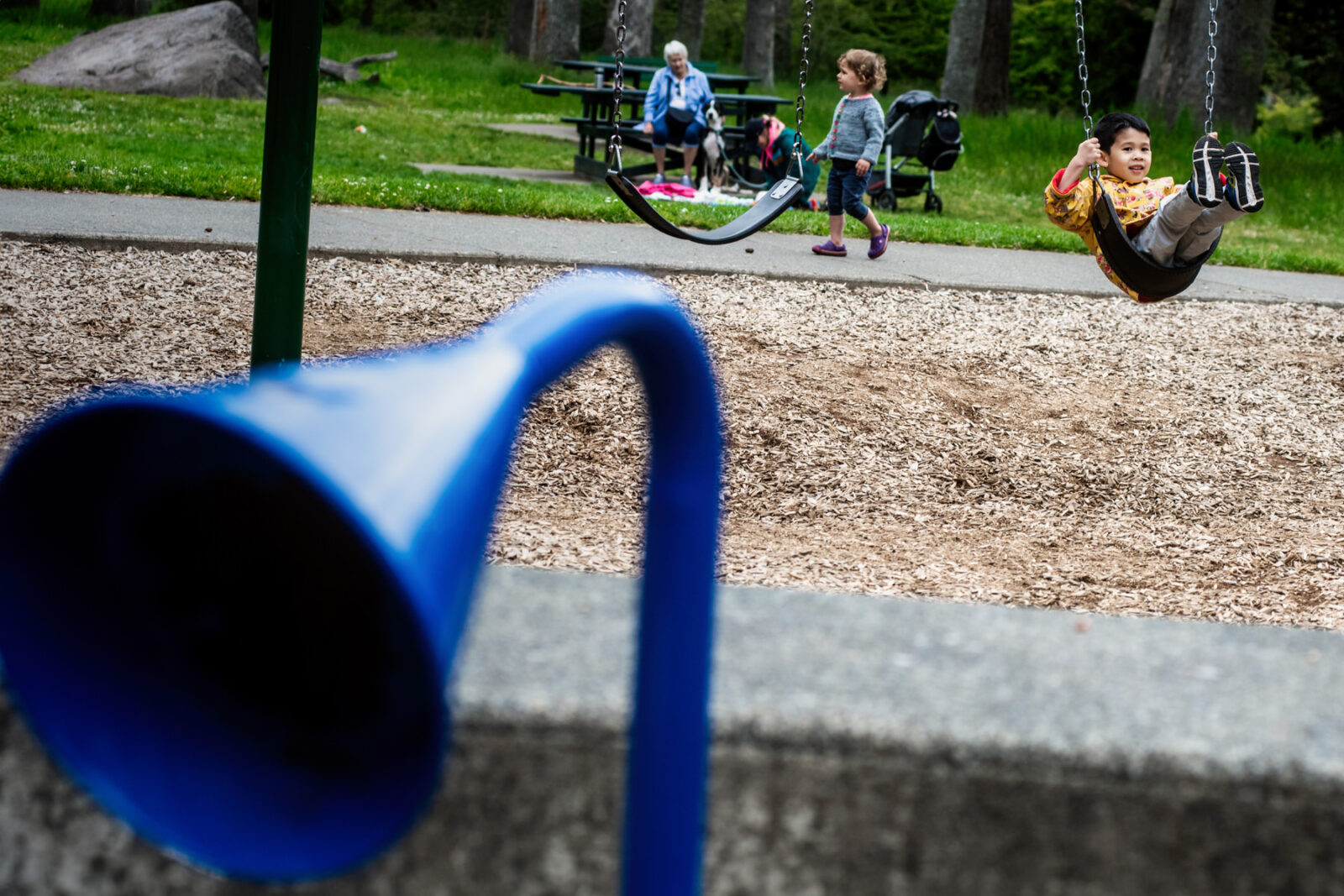 A child plays on the swings at Beacon Hill Park in Victoria BC