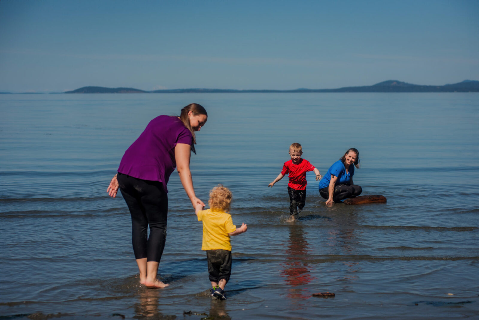 A colorful family photo that shows what to wear for beach portraits in Victoria BC.