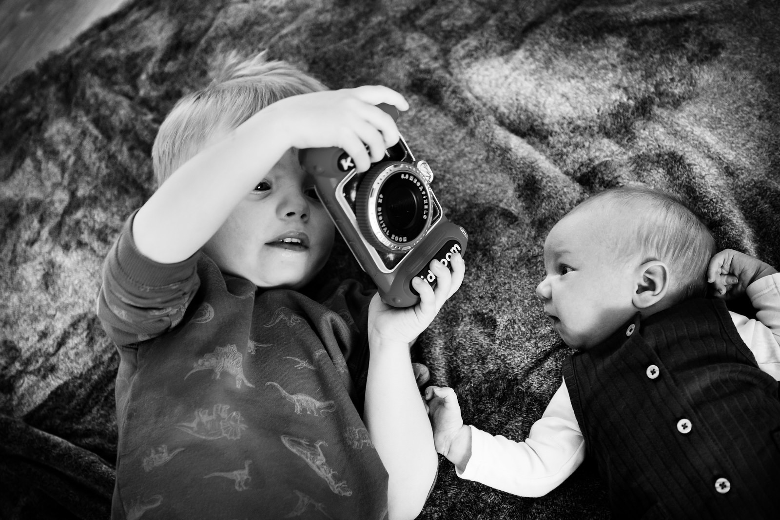 A toddler and his newborn brother in black and white in Victoria BC