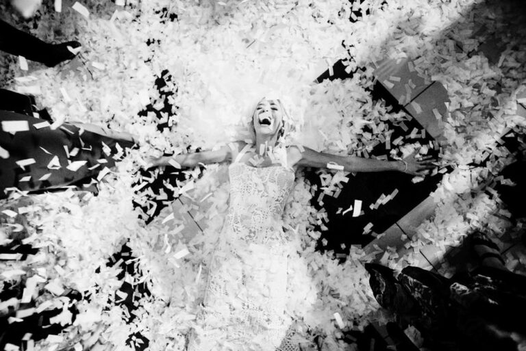 A bride surrounded by confetti in black and white in victoria bc